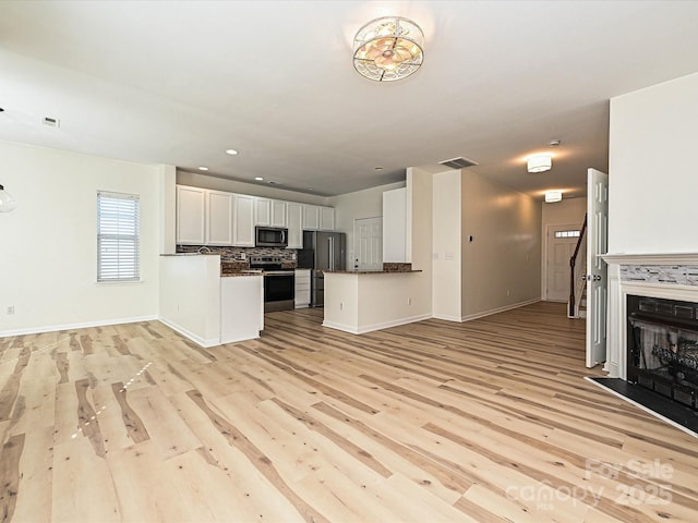 12131 Honor Guard Ave, Charlotte, NC 28277 - unfurnished living room featuring light wood finished floors, recessed lighting, and a fireplace