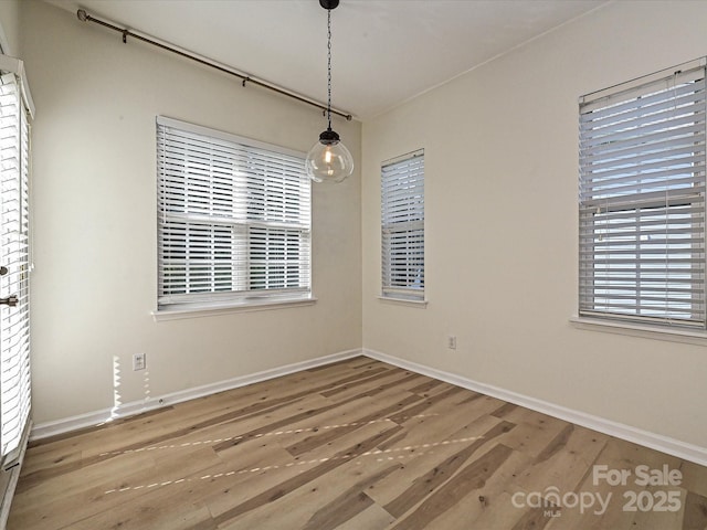 12131 Honor Guard Ave, Charlotte, NC 28277 - unfurnished dining area featuring wood finished floors and baseboards