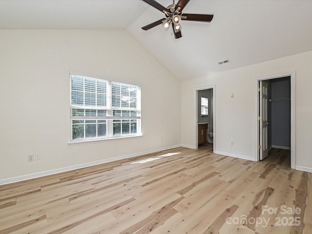 12131 Honor Guard Ave, Charlotte, NC 28277 - unfurnished bedroom with multiple windows, light wood-type flooring, vaulted ceiling, a spacious closet, and connected bathroom