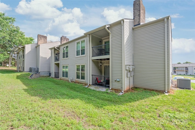 11069 Running Ridge Rd, Charlotte, NC 28226 - back of property featuring a chimney, a yard, and a balcony