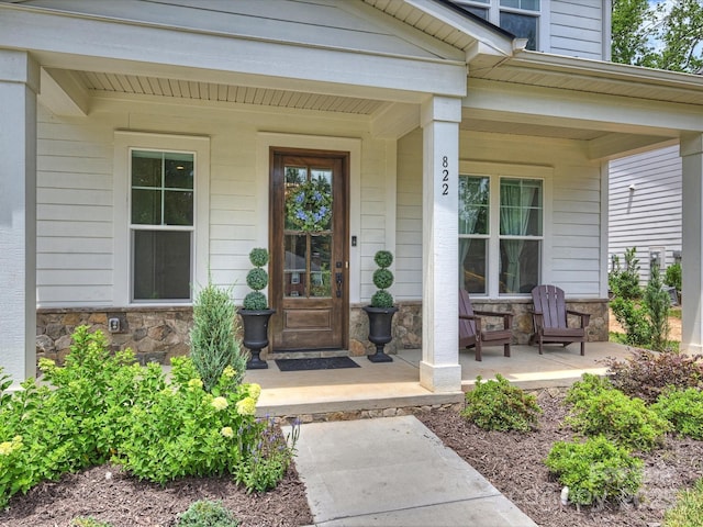 822 River Oaks Ln, Charlotte, NC 28226 - doorway to property featuring a porch and stone siding
