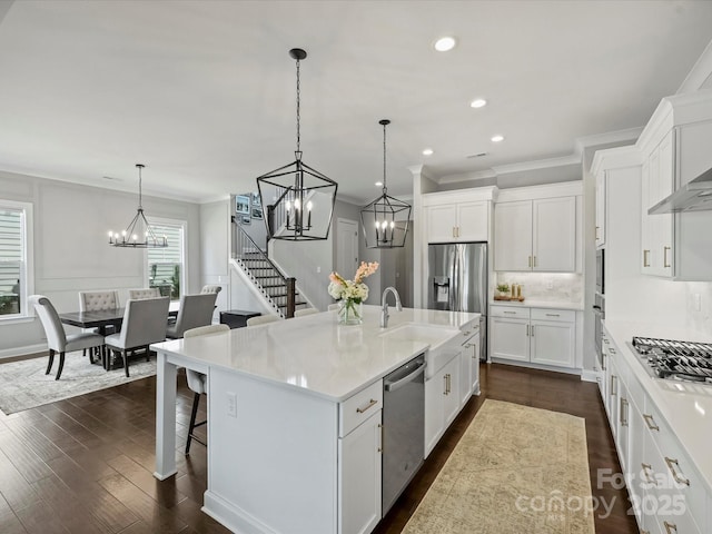 822 River Oaks Ln, Charlotte, NC 28226 - kitchen with appliances with stainless steel finishes, a chandelier, crown molding, white cabinetry, and light countertops