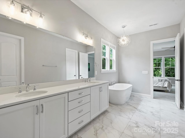 822 River Oaks Ln, Charlotte, NC 28226 - bathroom with double vanity, healthy amount of natural light, a freestanding tub, and a chandelier