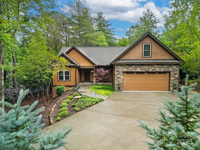 321 Middle Connestee Trl, Brevard, NC 28712 - craftsman-style home with concrete driveway, stone siding, roof with shingles, an attached garage, and board and batten siding