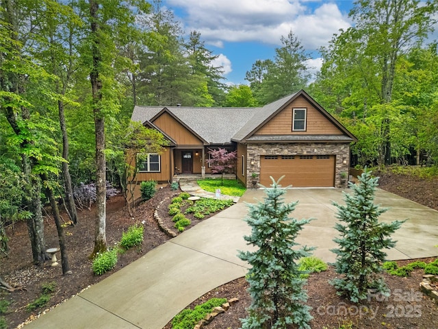 321 Middle Connestee Trl, Brevard, NC 28712 - craftsman house with concrete driveway, stone siding, a shingled roof, and an attached garage