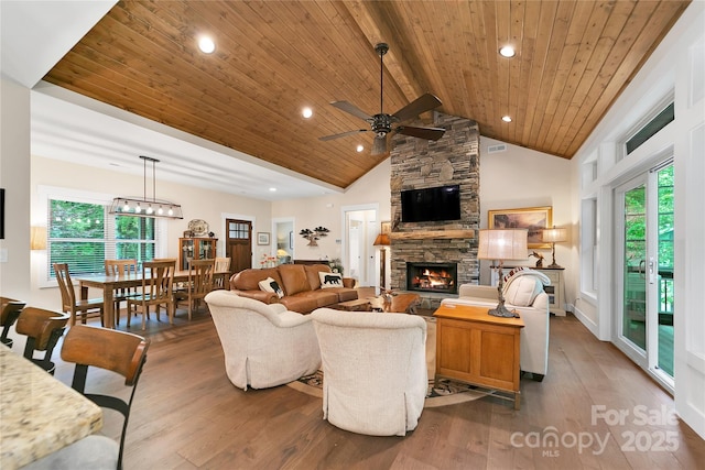 321 Middle Connestee Trl, Brevard, NC 28712 - living room with a ceiling fan, hardwood / wood-style flooring, a wood ceiling with exposed beams, a stone fireplace, and high vaulted ceiling