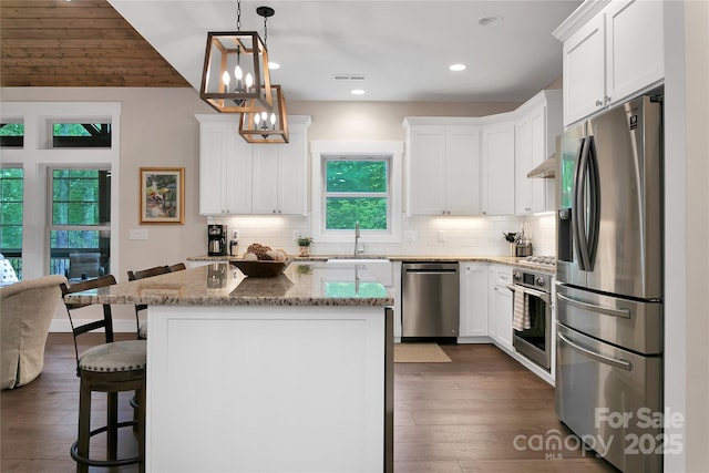 321 Middle Connestee Trl, Brevard, NC 28712 - kitchen with appliances with stainless steel finishes, decorative backsplash, white cabinets, and recessed lighting