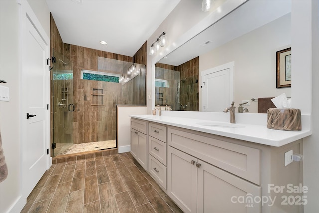 321 Middle Connestee Trl, Brevard, NC 28712 - full bathroom with double vanity, a shower stall, wood finish floors, and recessed lighting