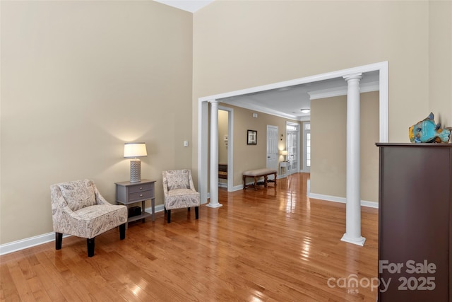 1119 Williamstown Rd, Matthews, NC 28105 - sitting room featuring decorative columns, ornamental molding, and light wood-type flooring