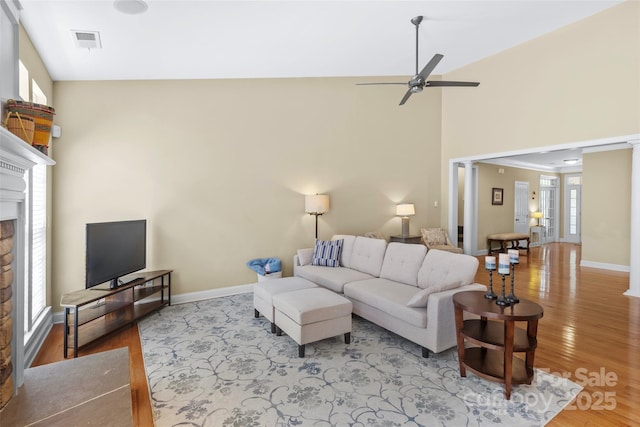 1119 Williamstown Rd, Matthews, NC 28105 - living area with a ceiling fan, wood finished floors, a fireplace, and high vaulted ceiling