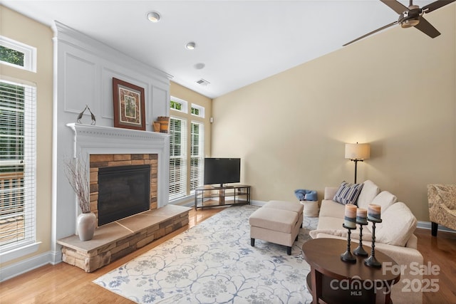 1119 Williamstown Rd, Matthews, NC 28105 - living room with a glass covered fireplace, wood finished floors, a ceiling fan, and recessed lighting