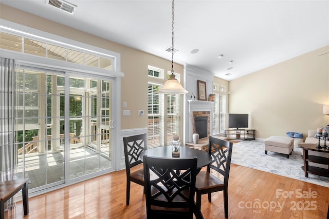 1119 Williamstown Rd, Matthews, NC 28105 - dining area with a stone fireplace and light wood-style flooring