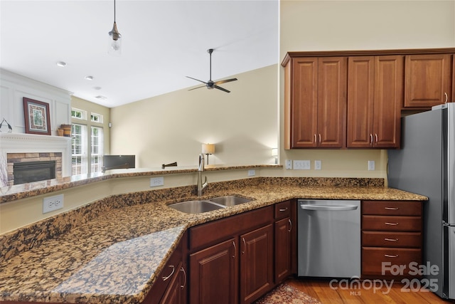 1119 Williamstown Rd, Matthews, NC 28105 - kitchen featuring appliances with stainless steel finishes, ceiling fan, a fireplace, and dark stone countertops