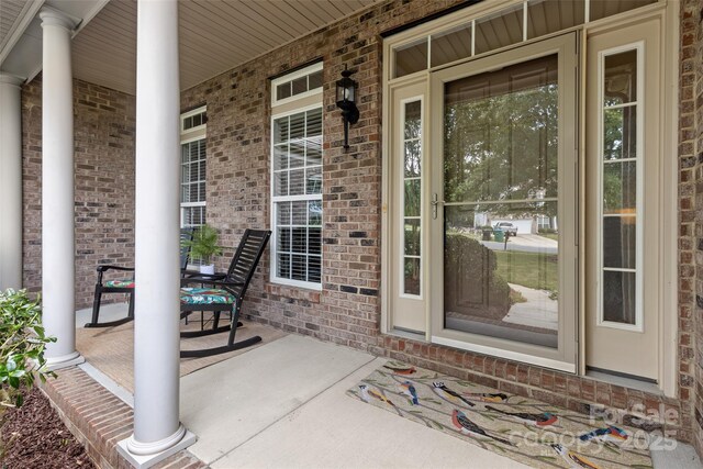 1119 Williamstown Rd, Matthews, NC 28105 - property entrance with a porch and brick siding