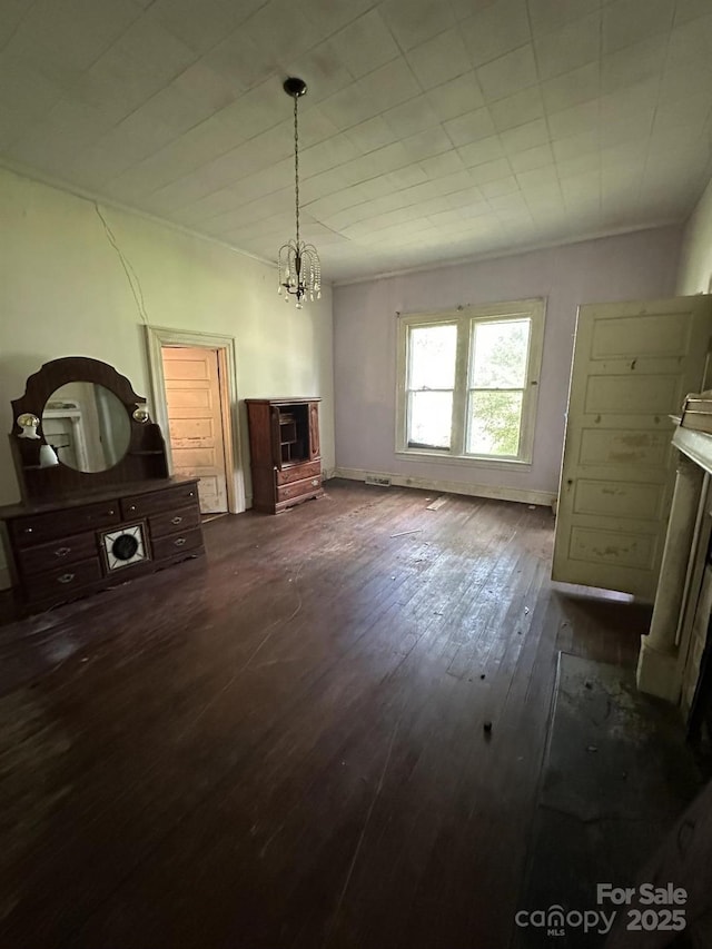 118 Hemphill Ave, Chester, SC 29706 - unfurnished living room with dark wood finished floors and a chandelier