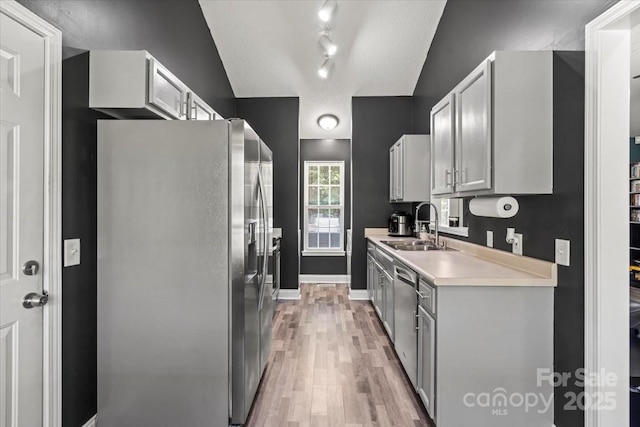 124 Turning Leaf Ln, Statesville, NC 28677 - kitchen featuring appliances with stainless steel finishes, light countertops, light wood-style floors, and gray cabinets