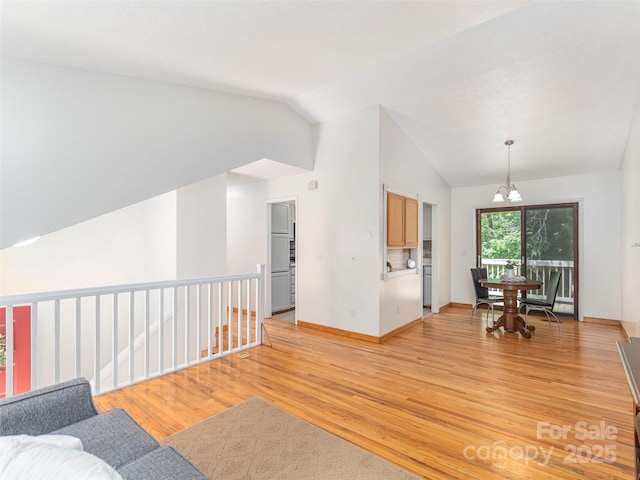 623 Nellie John Dr, Clyde, NC 28721 - living room featuring vaulted ceiling, a chandelier, and light wood finished floors