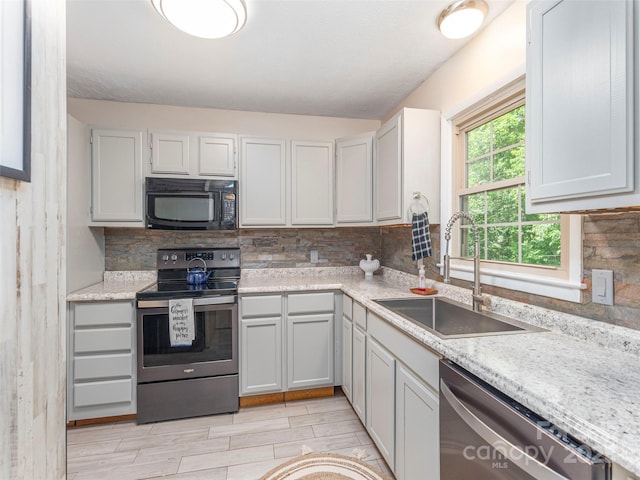 623 Nellie John Dr, Clyde, NC 28721 - kitchen with appliances with stainless steel finishes, light countertops, tasteful backsplash, and wood tiled floors