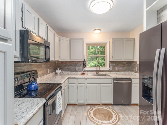 623 Nellie John Dr, Clyde, NC 28721 - kitchen with stainless steel appliances, decorative backsplash, and light wood-style floors