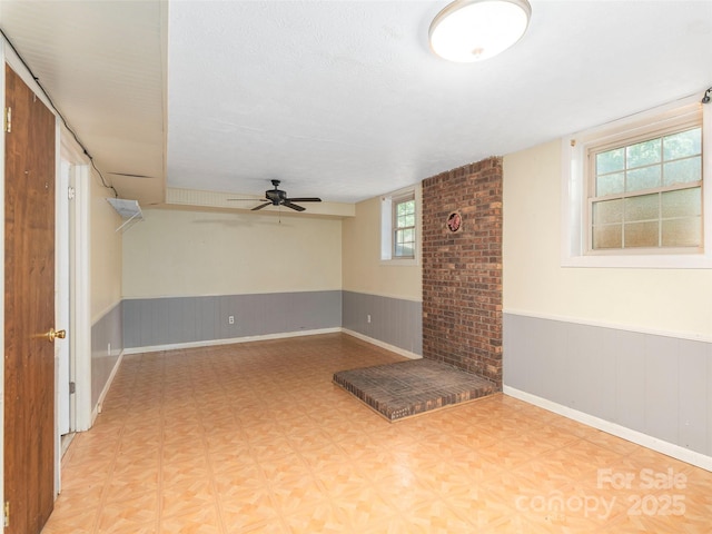 623 Nellie John Dr, Clyde, NC 28721 - below grade area featuring a wainscoted wall and ceiling fan