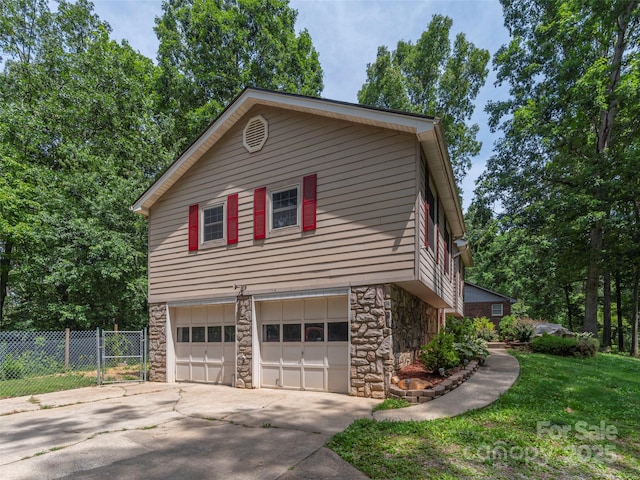 623 Nellie John Dr, Clyde, NC 28721 - view of home's exterior with stone siding, a garage, and concrete driveway