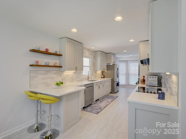 116 Hallett St, Fort Mill, SC 29715 - kitchen featuring appliances with stainless steel finishes, tasteful backsplash, a kitchen breakfast bar, recessed lighting, and a peninsula