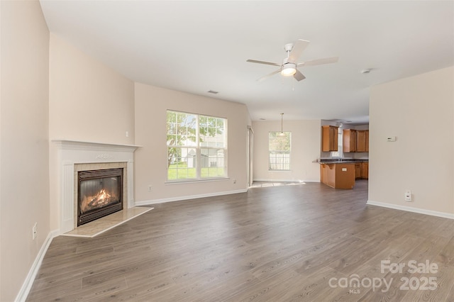 5307 Ayers Orchard Way, Charlotte, NC 28227 - unfurnished living room with light wood finished floors, a ceiling fan, and a fireplace