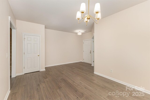 5307 Ayers Orchard Way, Charlotte, NC 28227 - empty room with a chandelier and wood finished floors