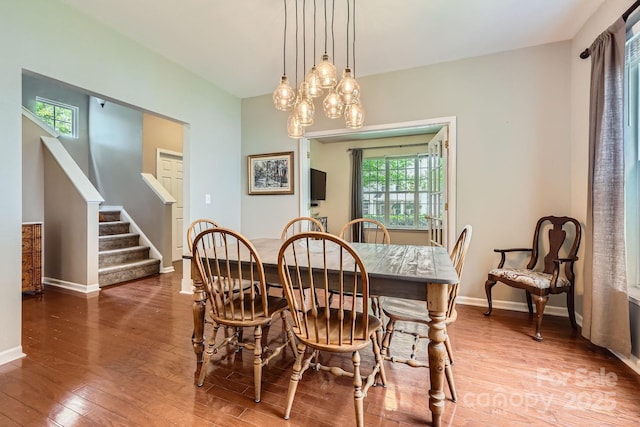 10132 Caldwell Depot Rd, Cornelius, NC 28031 - dining space featuring wood-type flooring, stairway, and a chandelier