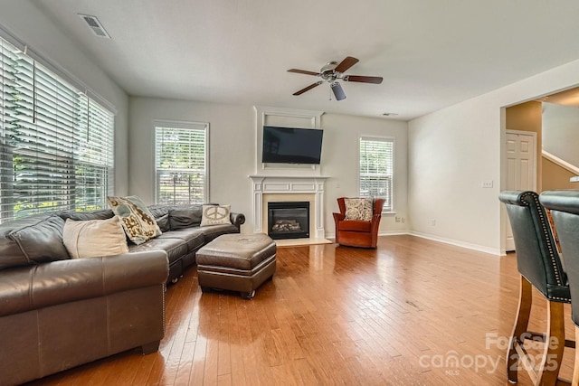10132 Caldwell Depot Rd, Cornelius, NC 28031 - living room featuring hardwood / wood-style floors, a ceiling fan, and a glass covered fireplace