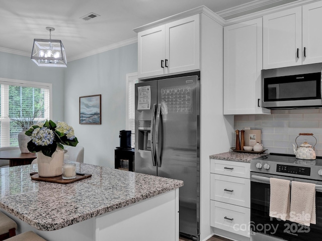 720 4th St, Stanley, NC 28164 - kitchen featuring stainless steel appliances, ornamental molding, light stone counters, tasteful backsplash, and a chandelier