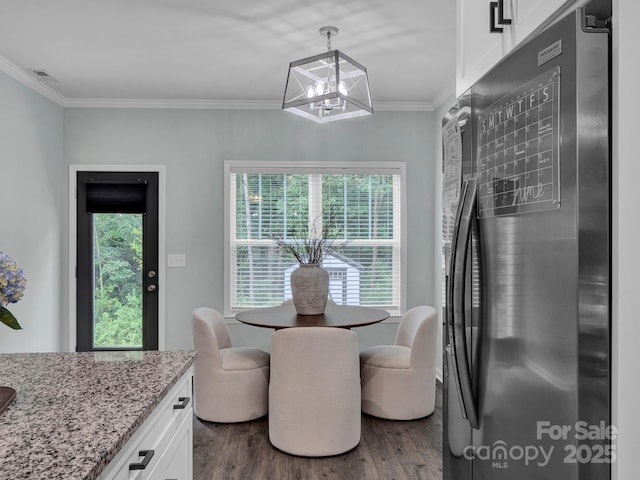 720 4th St, Stanley, NC 28164 - dining room with dark wood-type flooring, a chandelier, and crown molding