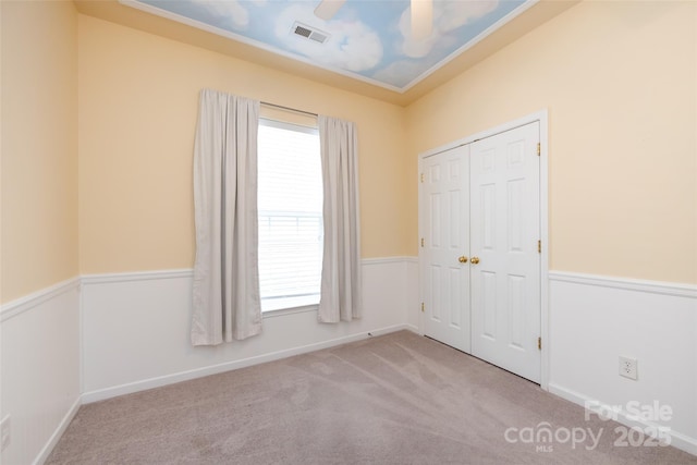 1040 Stonedown Ln, Matthews, NC 28104 - unfurnished bedroom with multiple windows, carpet flooring, a closet, and ceiling fan