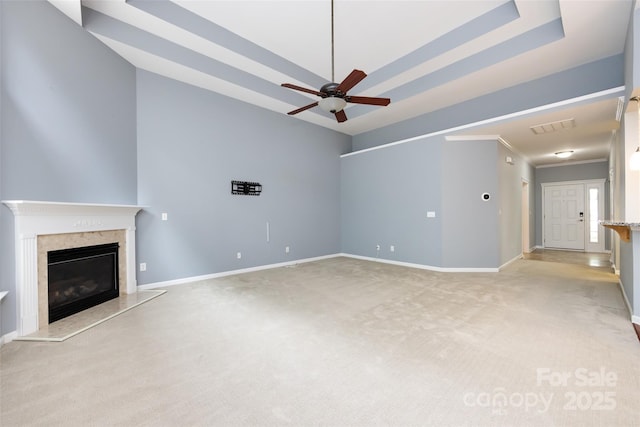 1040 Stonedown Ln, Matthews, NC 28104 - unfurnished living room with ceiling fan, light colored carpet, a premium fireplace, and a tray ceiling