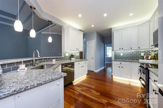 1040 Stonedown Ln, Matthews, NC 28104 - kitchen with stainless steel appliances, decorative backsplash, white cabinetry, light stone countertops, and recessed lighting