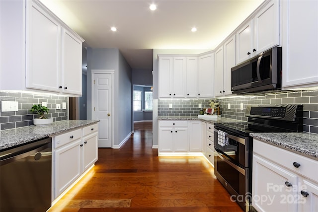 1040 Stonedown Ln, Matthews, NC 28104 - kitchen with stainless steel appliances, dark wood-style flooring, white cabinetry, backsplash, and recessed lighting