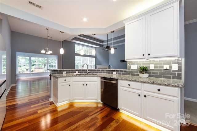 1040 Stonedown Ln, Matthews, NC 28104 - kitchen with stainless steel dishwasher, a peninsula, light wood-style floors, light stone counters, and white cabinets