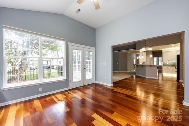 1040 Stonedown Ln, Matthews, NC 28104 - unfurnished living room with french doors, a ceiling fan, hardwood / wood-style floors, healthy amount of natural light, and lofted ceiling