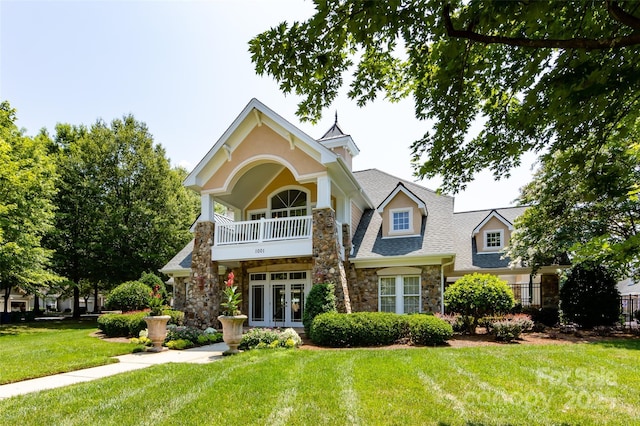1040 Stonedown Ln, Matthews, NC 28104 - view of front of property featuring stone siding, french doors, a front lawn, roof with shingles, and a balcony
