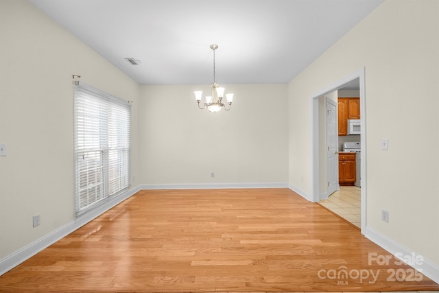 104 Mooreland Dr NE, Conover, NC 28613 - empty room featuring a chandelier and light wood-type flooring
