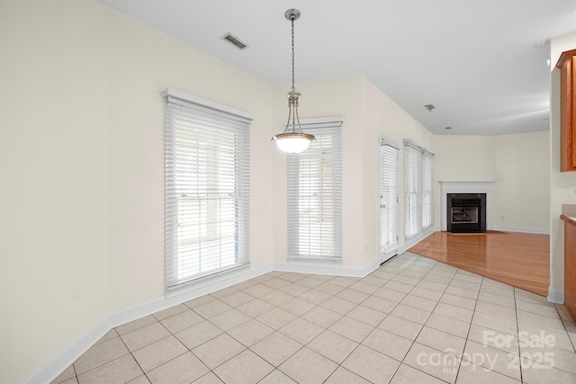 104 Mooreland Dr NE, Conover, NC 28613 - unfurnished dining area with a fireplace with flush hearth and light tile patterned flooring