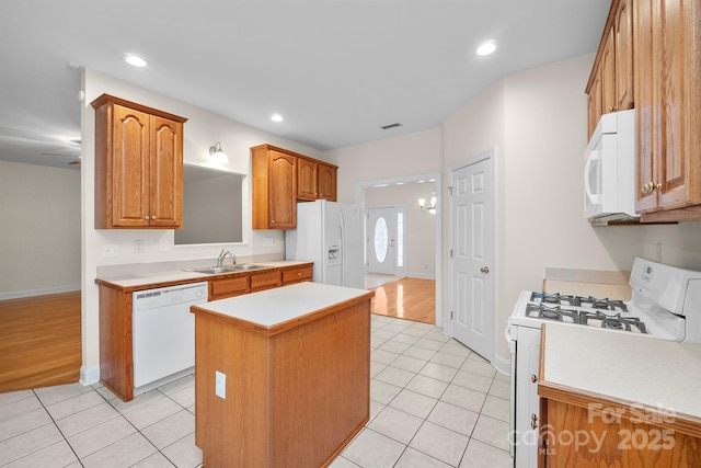 104 Mooreland Dr NE, Conover, NC 28613 - kitchen with white appliances, a center island, light countertops, light tile patterned floors, and recessed lighting