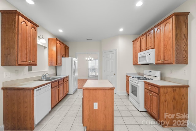 104 Mooreland Dr NE, Conover, NC 28613 - kitchen featuring white appliances, a kitchen island, light countertops, a chandelier, and light tile patterned floors