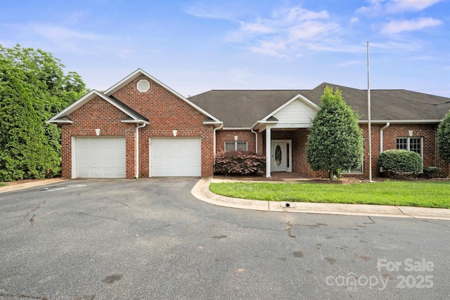 104 Mooreland Dr NE, Conover, NC 28613 - view of front facade with a garage, asphalt driveway, brick siding, and a shingled roof