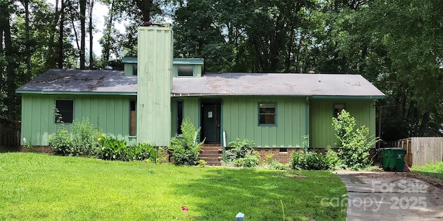7705 Stone Canyon Ln, Charlotte, NC 28227 - mid-century modern home featuring a chimney and board and batten siding