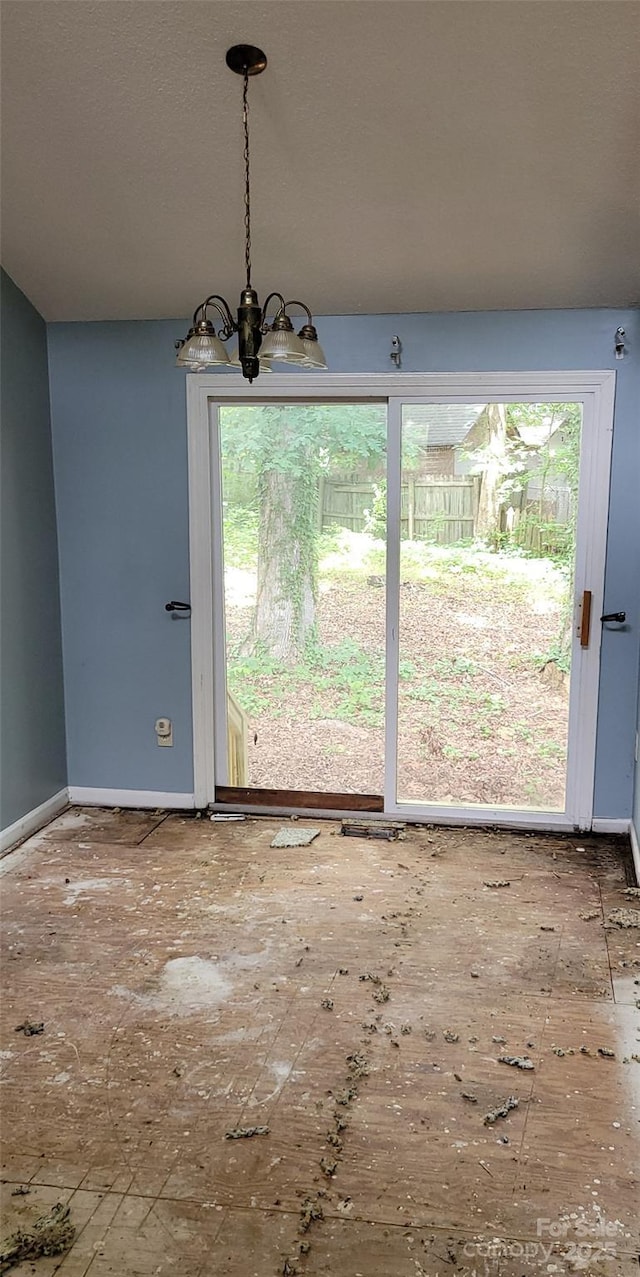 7705 Stone Canyon Ln, Charlotte, NC 28227 - unfurnished dining area featuring a chandelier and baseboards