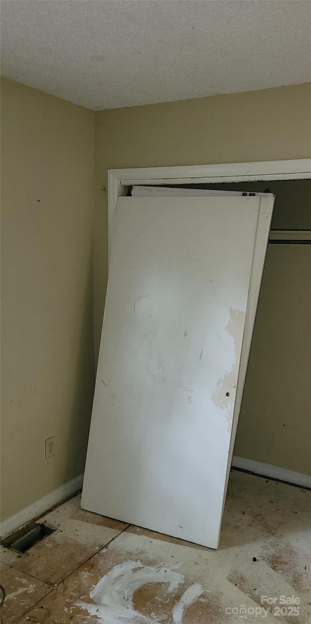 7705 Stone Canyon Ln, Charlotte, NC 28227 - unfurnished bedroom with a closet and a textured ceiling