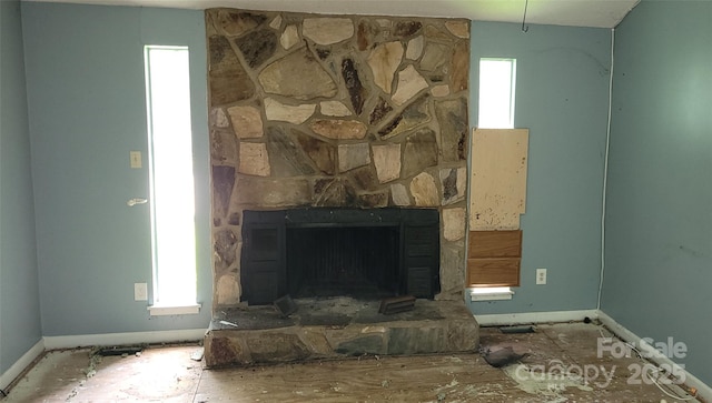 7705 Stone Canyon Ln, Charlotte, NC 28227 - living area featuring baseboards and a stone fireplace