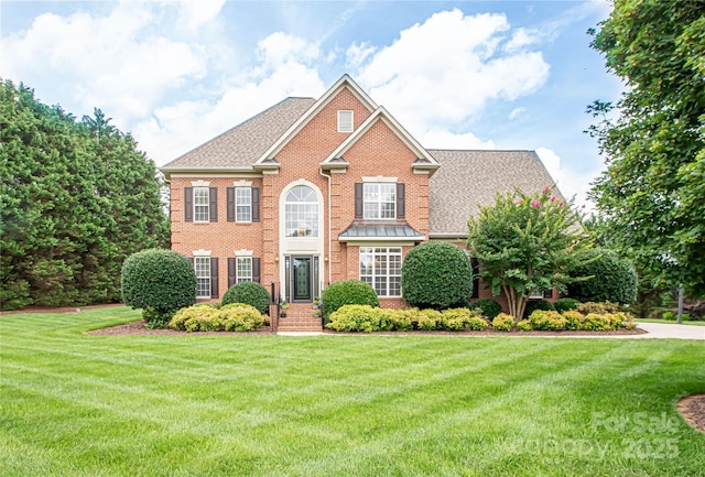 2019 Heirloom Ct, Matthews, NC 28104 - view of front of home featuring brick siding, a front yard, and a shingled roof