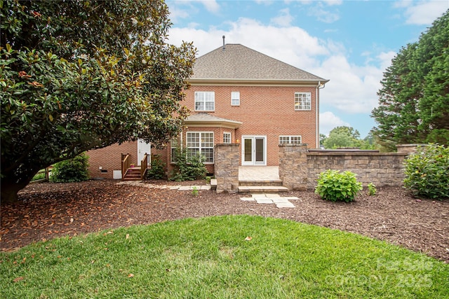 2019 Heirloom Ct, Matthews, NC 28104 - rear view of property featuring brick siding, entry steps, a yard, and roof with shingles
